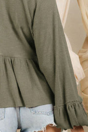 Textured ribbed peplum blouse in matcha green with ruffled cuffs