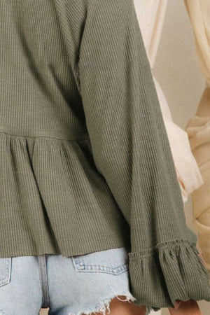Textured ribbed peplum blouse in matcha green with ruffled cuffs