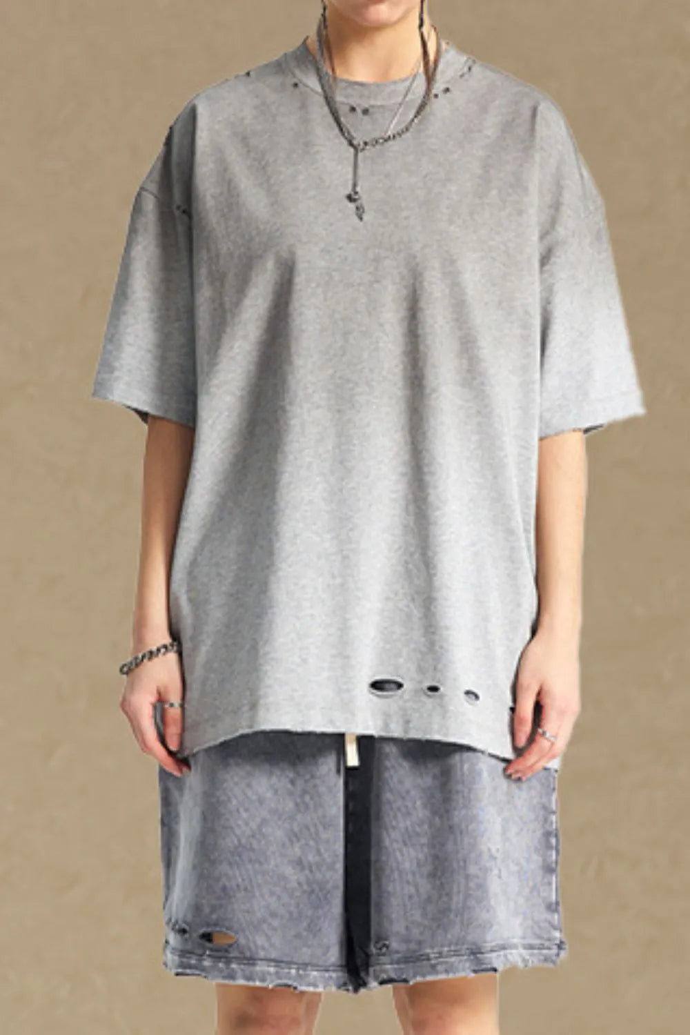 Gray oversized t-shirt with distressed neckline and hemline details.