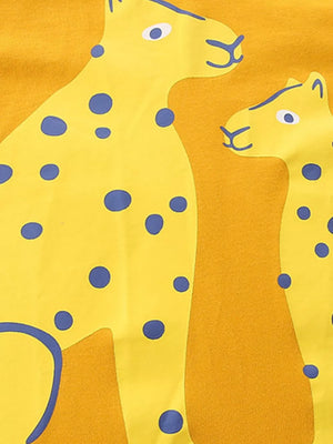 Yellow cotton t-shirt with playful blue spotted leopard graphic.