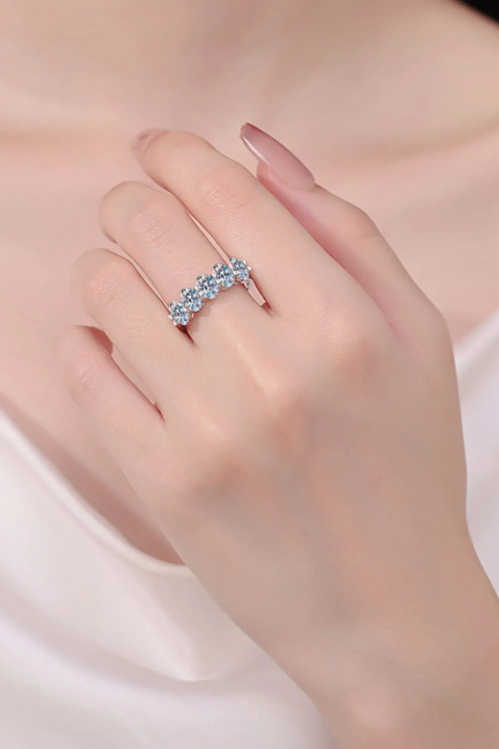 Silver band ring with five round clear stones in a celestial cluster design.