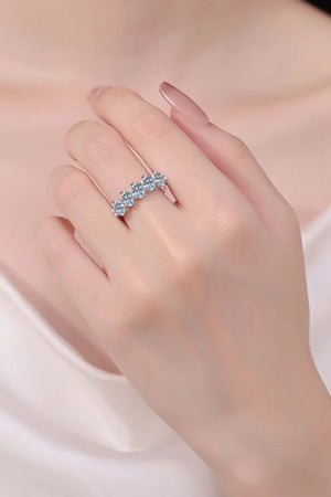 Silver band ring with five round clear stones in a celestial cluster design.