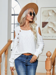 White cable knit cold-shoulder sweater with button detail and square neckline.