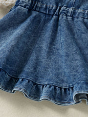 Adjustable denim overall dress for kids with ruffled hem and elastic waistband.