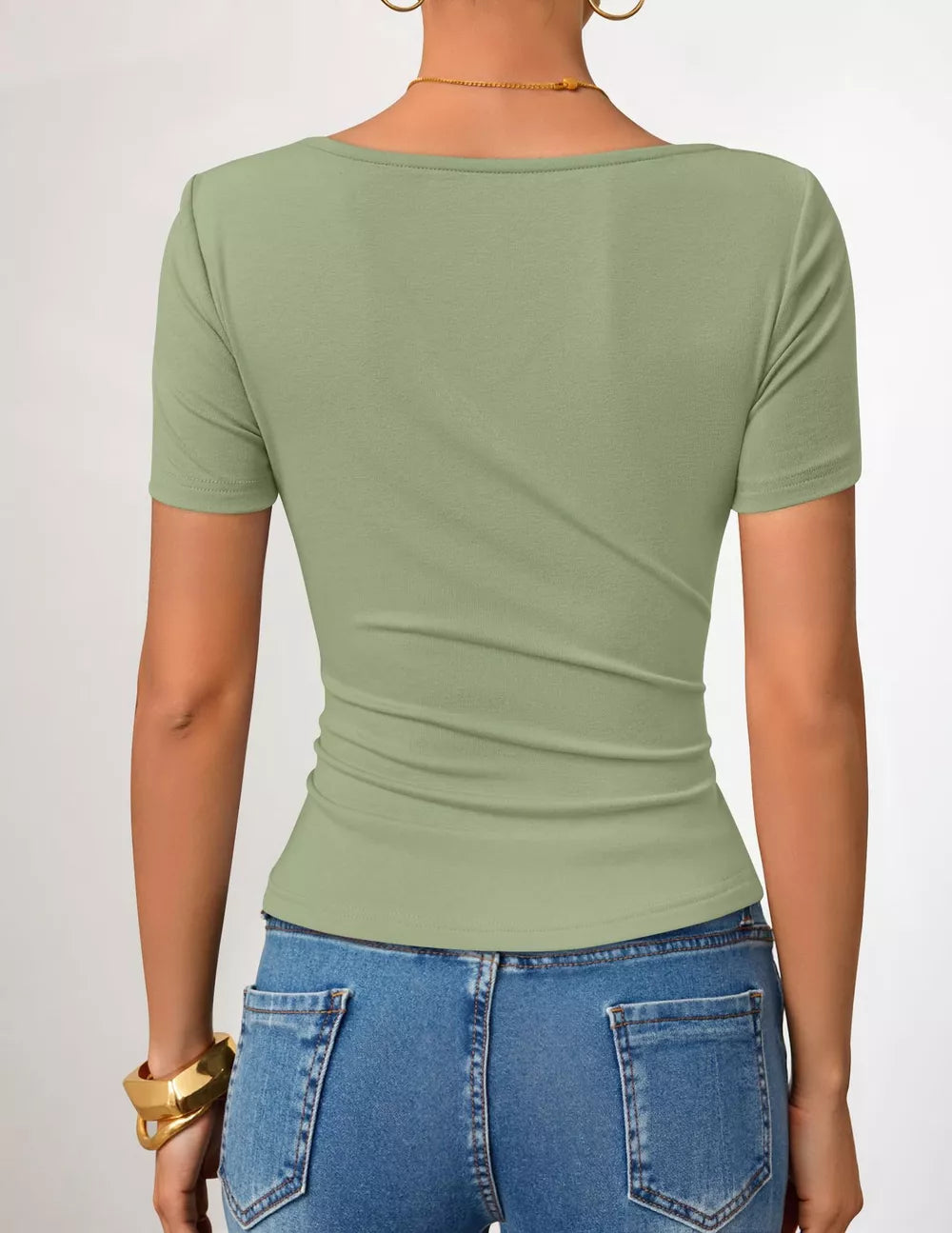 Green asymmetrical fitted maternity t-shirt with short sleeves and a scoop neckline.