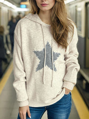 Beige knit hoodie with gray textured star appliqué and drawstring hood.