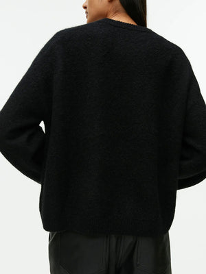 Oversized black brushed knit crewneck sweater with crew neckline and long sleeves.