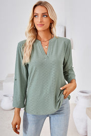 Light Green textured henley shirt with v-neck and roll-tab sleeves.