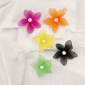 Vibrant floral pearl stud earrings in white, pink, yellow, green, orange, and black.