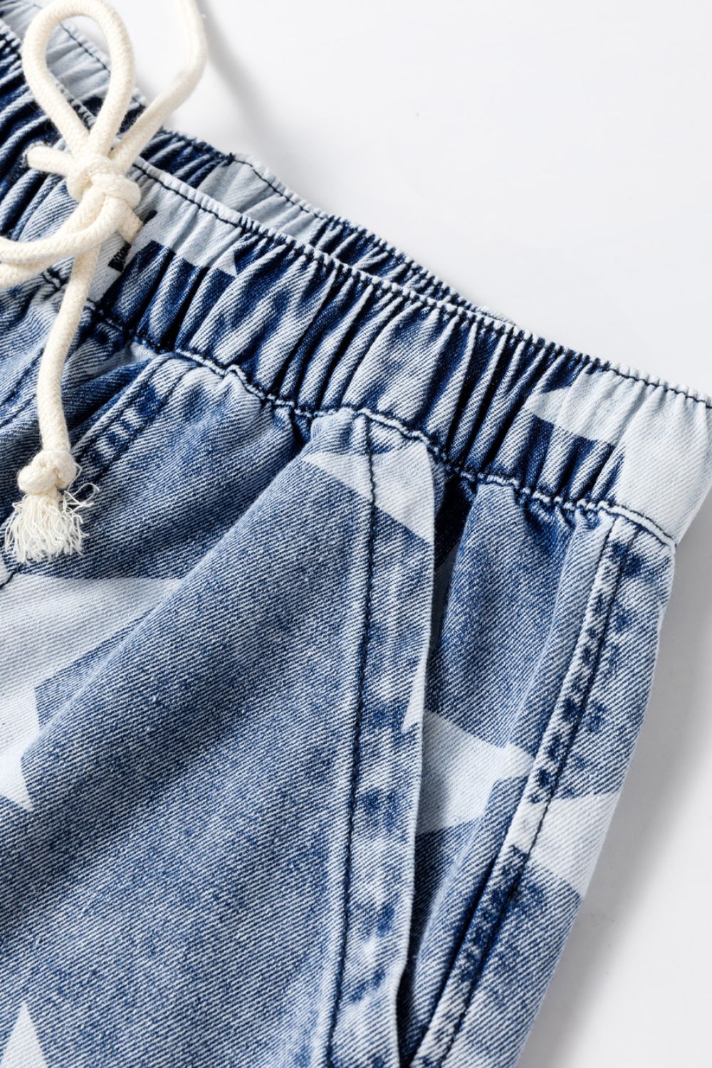 Cosmic Wash Star Print Palazzo Jeans in medium blue denim with drawstring waist and elastic waistband.