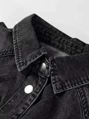 Black denim button-up dress with a collared neckline and silver snap buttons.