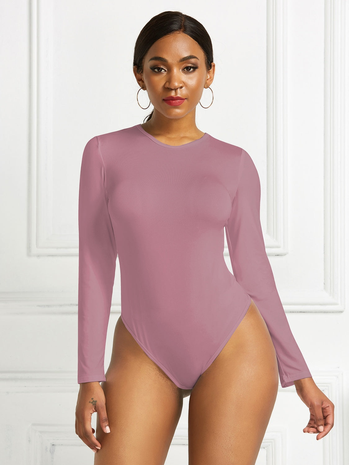 Sculpted ribbed jersey bodysuit in dusty pink with long sleeves and a crew neck.