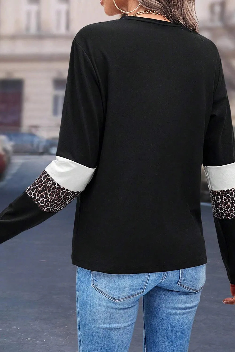 Black long sleeve tee with white and leopard print sleeve panels.