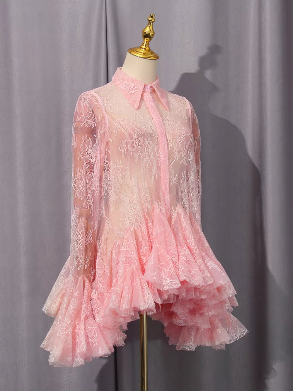 Pink floral lace dress with buttoned collar and ruffled hem.