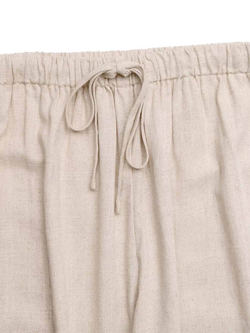 Relaxed drawstring wide-leg trousers in natural linen with a tie waist.