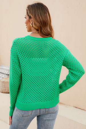 Green open-knit crewneck sweater with subtle texture and long sleeves.