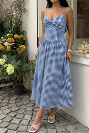 Blue gingham midi dress with knot-front bodice and spaghetti straps.
