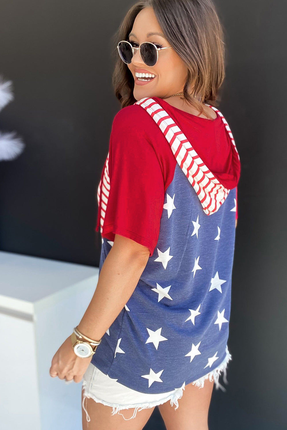Patriotic raglan hooded tee in scarlet with white stars and striped hood lining.