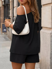 Black asymmetrical one-shoulder top and shorts set with pockets.