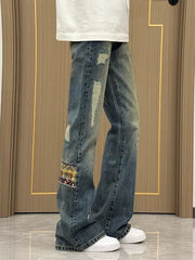 Distressed blue wash wide-leg jeans with patchwork detail and 100% cotton fabric.