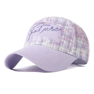 Purple plaid baseball cap with embroidered "future" detail and lavender brim.