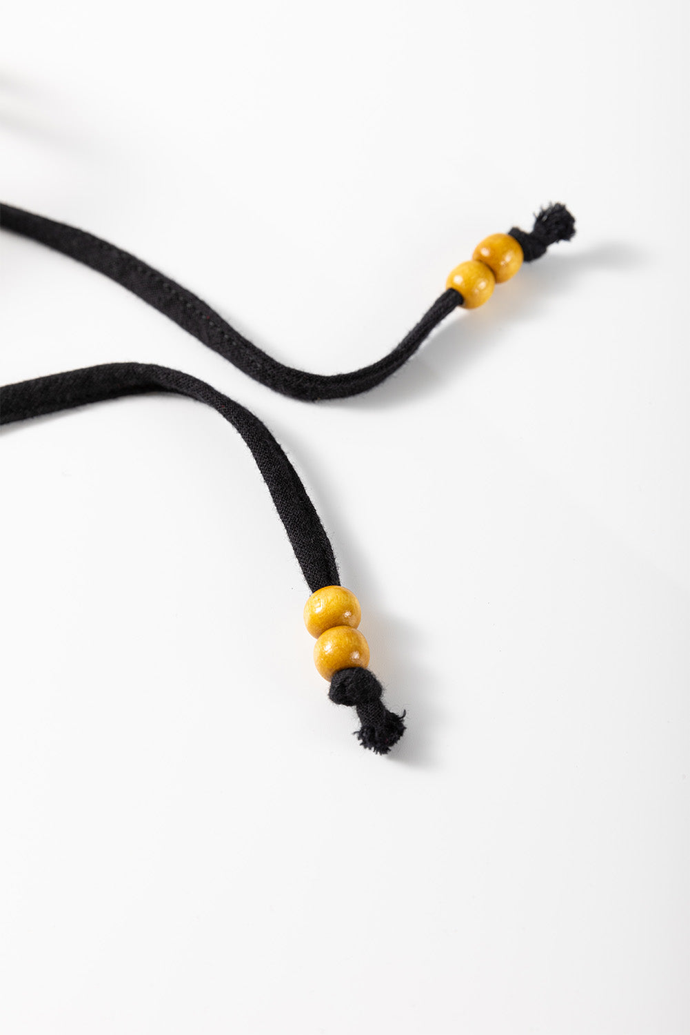 Black blouse drawstring with wooden beads and tassel detail