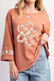 Floral appliqué sweatshirt in Sherbet with raglan sleeves and floral trim cuffs.