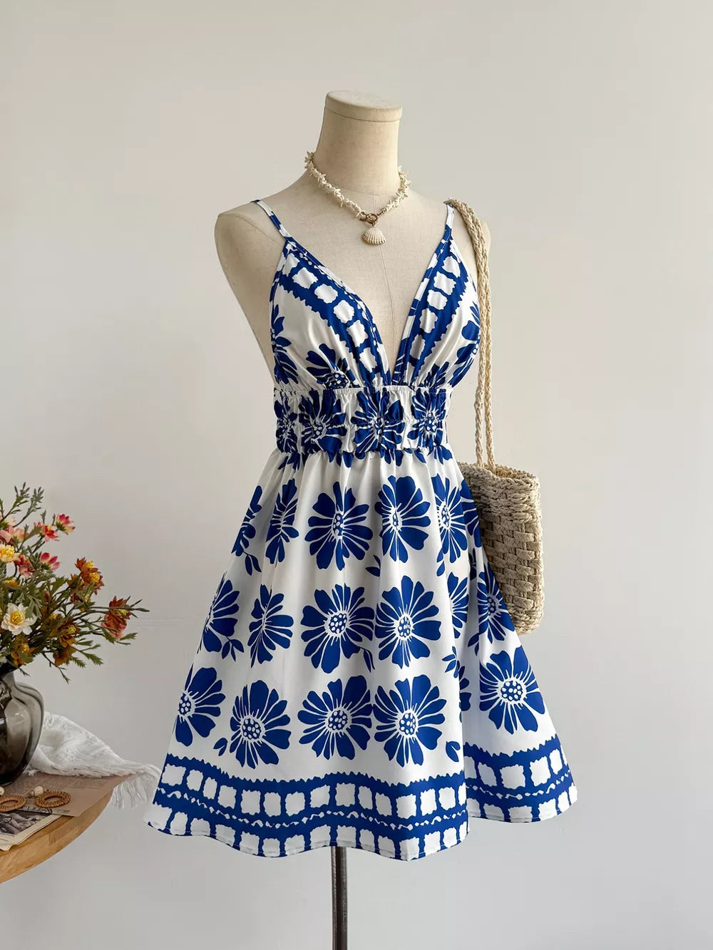 Floral v-neck mini dress with smocked waist and blue floral print.