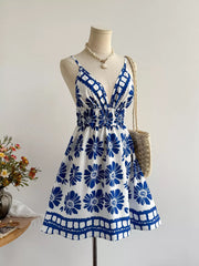 Floral v-neck mini dress with smocked waist and blue floral print.