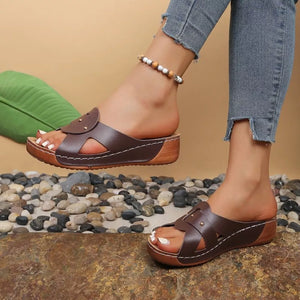Brown embellished open-toe wedge sandals with decorative straps and contrast stitching.