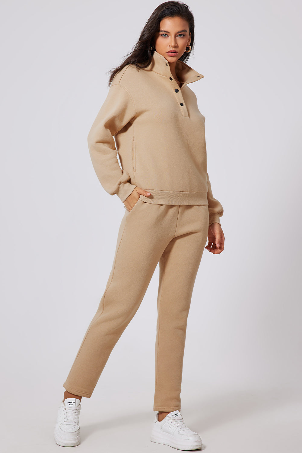 Button-neck lounge set in dust storm beige, featuring a high collar and snap closure.