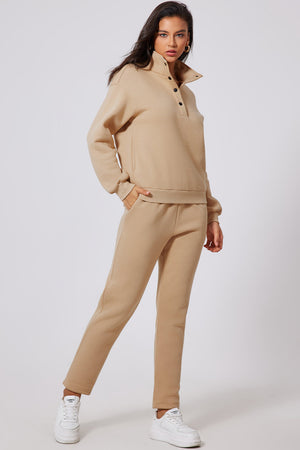 Button-neck lounge set in dust storm beige, featuring a high collar and snap closure.