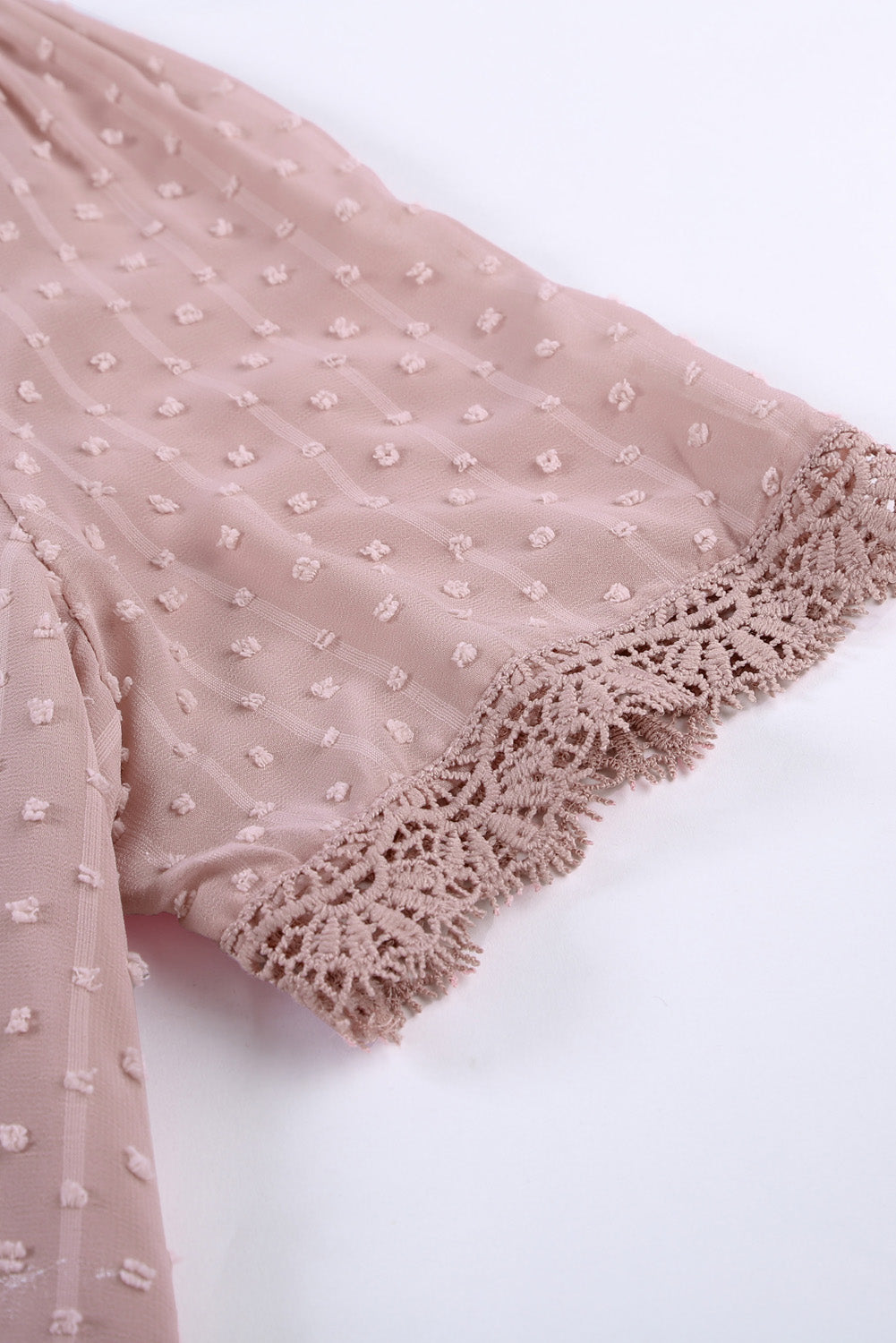 Dotted Swiss lace trim blouse in dusty pink with short sleeves and crochet detail.