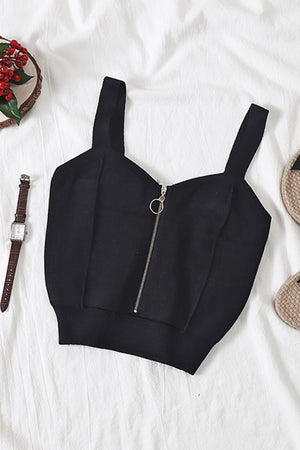 Black ribbed knit crop top with exposed zipper detail and wide straps.