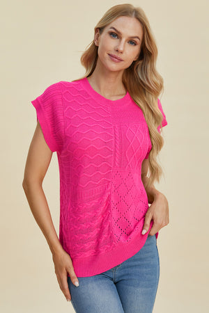 Hot pink knit patchwork top with short sleeves and mixed cable and open knit textures.