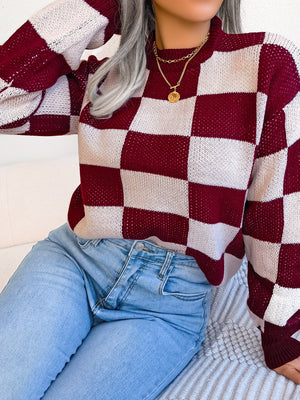 Burgundy and white checkerboard knit mock neck pullover sweater with textured details.