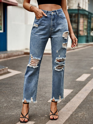 Medium wash denim jeans with ripped knees and raw hem straight leg cut.