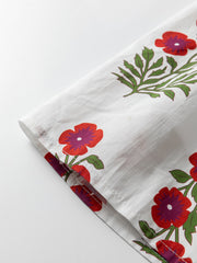 V-neck mini dress in white cotton with red floral print and pockets detail