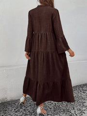 Brown tiered ruffle hem dress with bell sleeves and a button front, styled with white heels.
