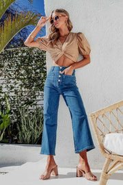 Button-front cropped wide-leg jeans in light blue denim with a high waist and patch pockets.