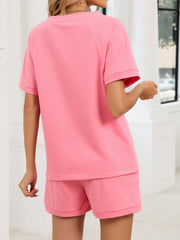 Pink loungewear shorts and matching t-shirt with short sleeves and crew neck.
