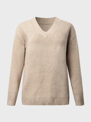Tan knit sweater with V-neck and ribbed trim details.