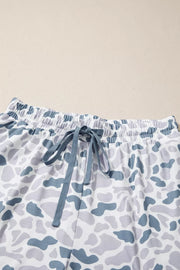 Pajama shorts with blue and gray camouflage print, elastic waistband, and drawstring tie.