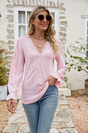 Blush pink eyelet lace blouse with ruffle sleeves and V-neck.