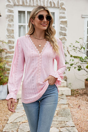 Blush pink eyelet lace blouse with ruffle sleeves and V-neck.