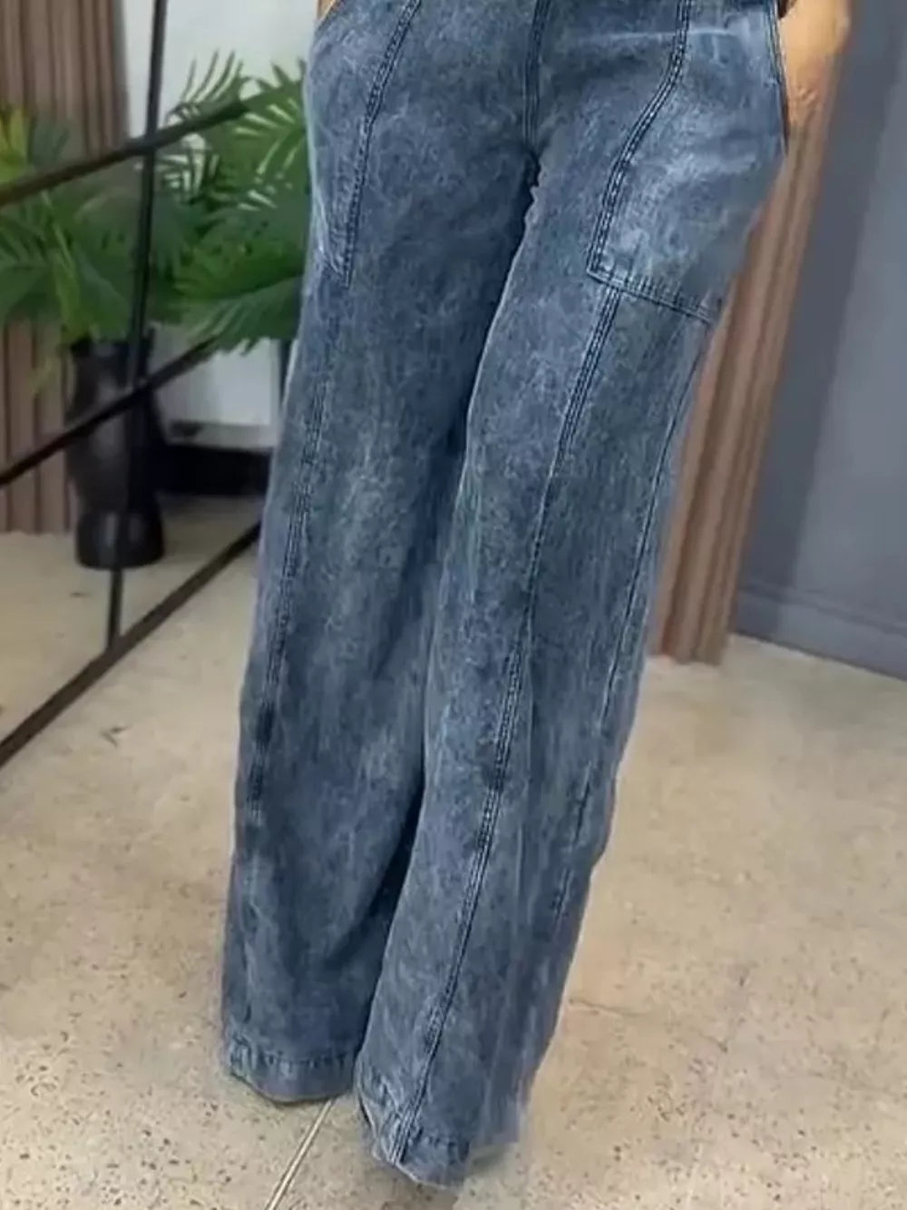 Vintage wash wide-leg denim overalls in blue with a relaxed fit and cargo pocket detail.