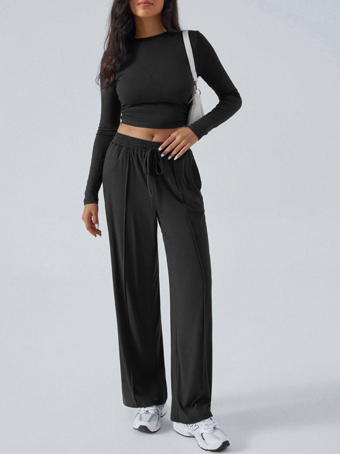 Black ribbed knit crop top and wide leg pants set with drawstring waist.