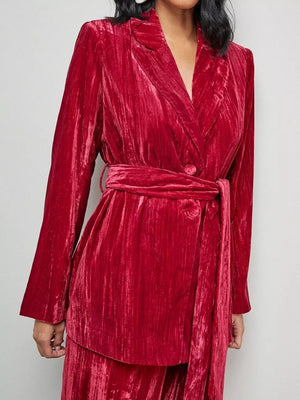 Burgundy velvet belted blazer and trousers ensemble with a textured finish.