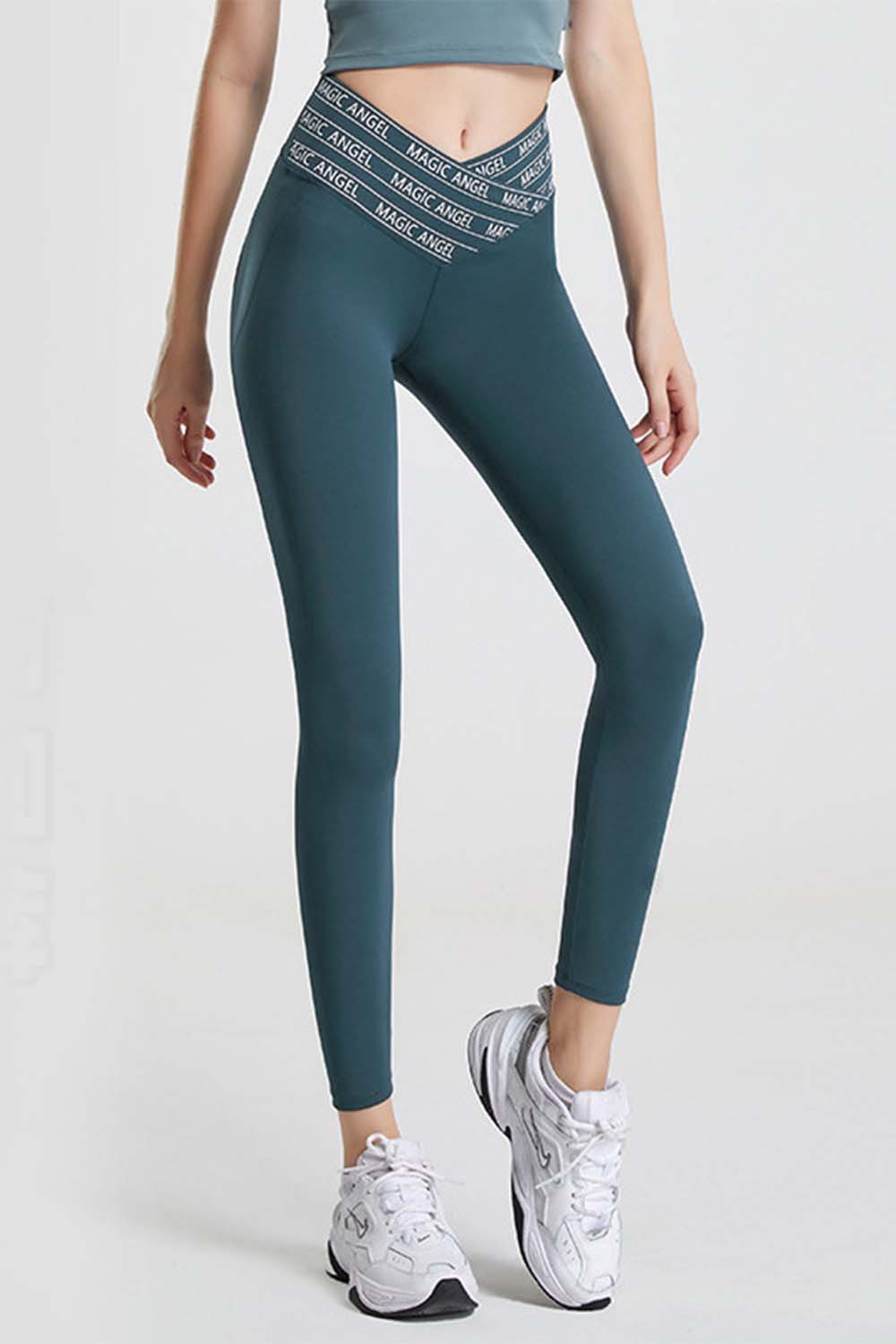 Deep teal Angel Band active leggings with a V-waistband and repeating logo detail.