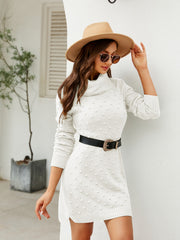 White textured turtleneck sweater dress with a slit, acrylic knit, long sleeves, and a side slit.